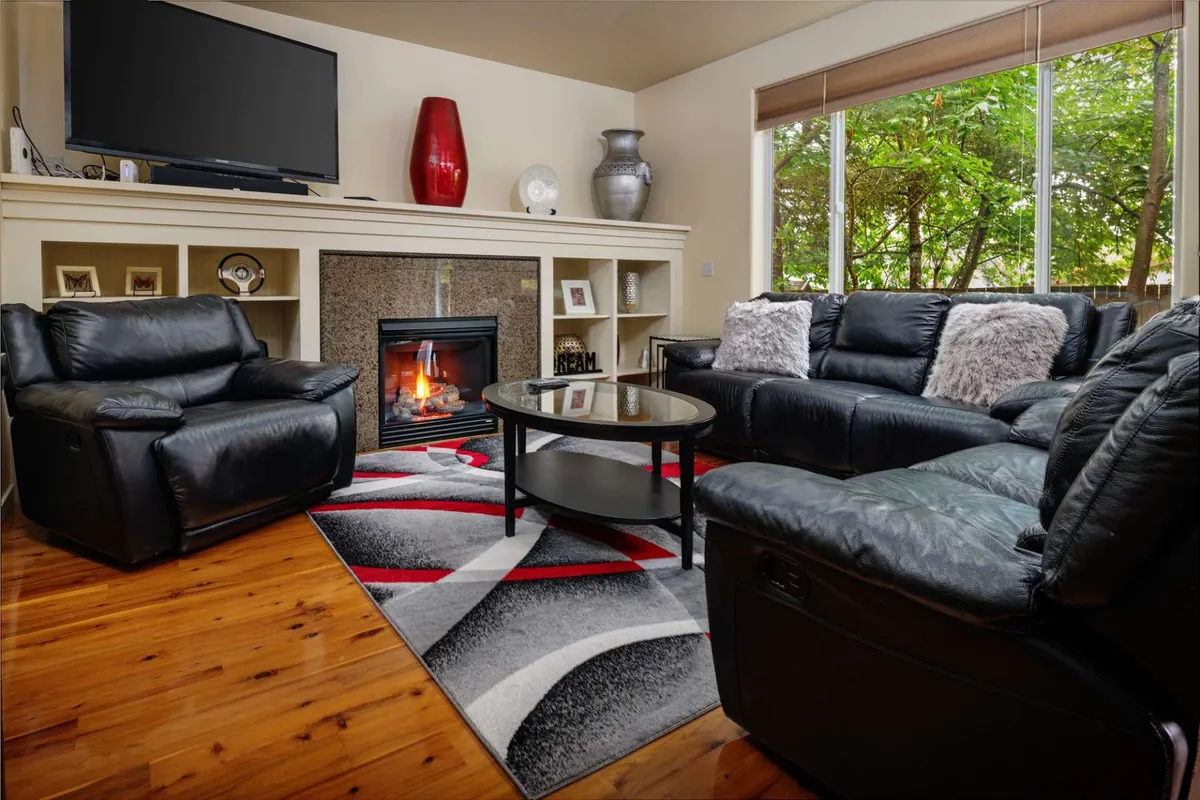 The hero image showcases a beautifully arranged living room with plush sofas surrounding a modern fireplace, a stylish coffee table topped with a decorative vase, and large windows inviting in natural light. The scene feels warm, inviting, and perfect for lounging or gathering with friends and family.