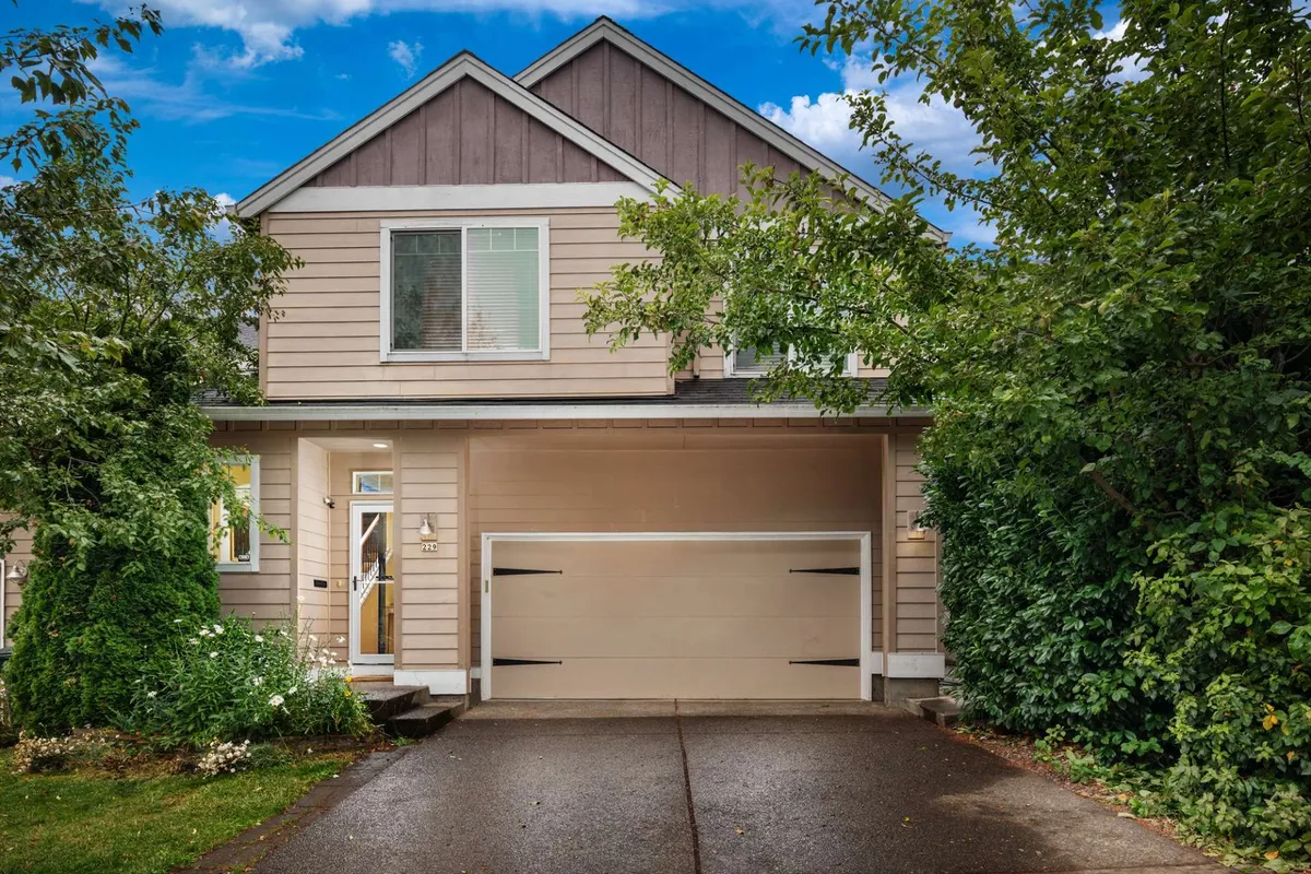 This image features the welcoming facade of The 229, with a neatly landscaped front yard, garage door, and inviting front entrance. The well-maintained exterior suggests ease of arrival and a pleasant setting for both short and long stays. Visible touches of greenery and a comfortable porch evoke a sense of homecoming after a busy day.